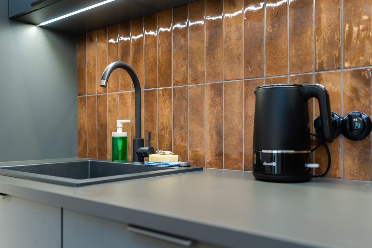 Spotless modern kitchen counter and sink after cleaning